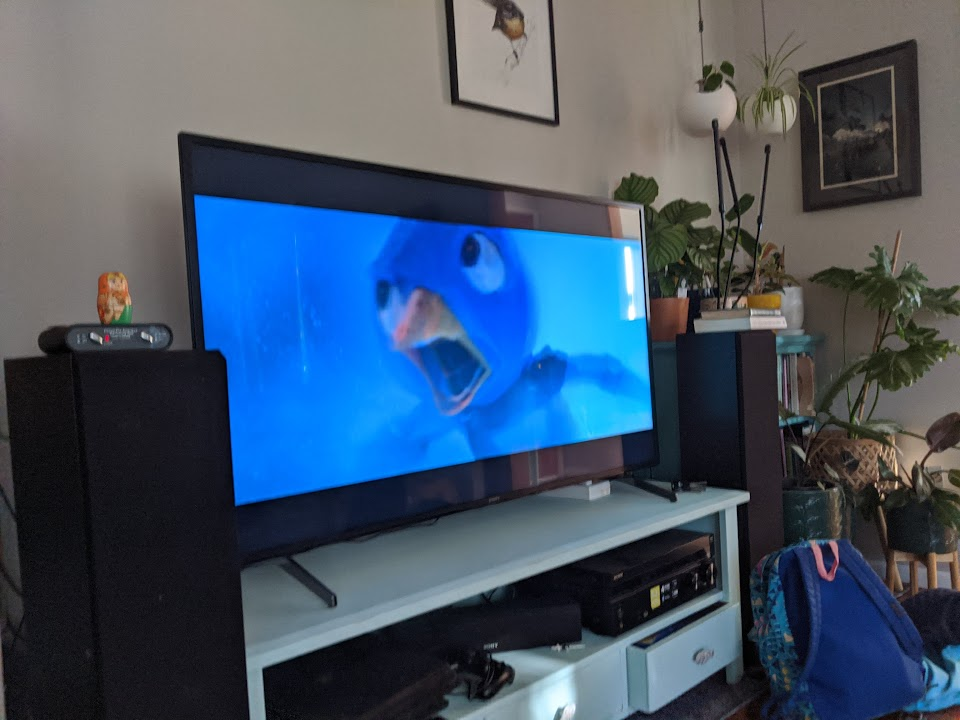 A living room television showing a still from the film Super Mario Brothers.